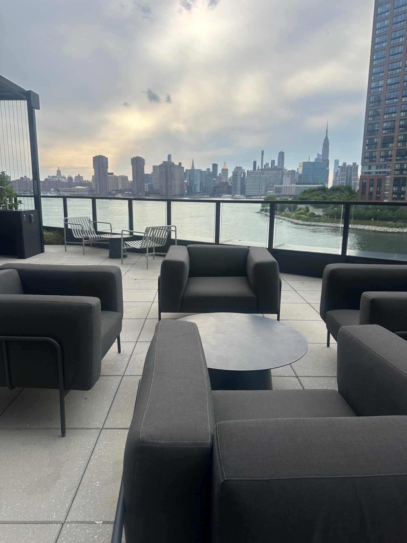 Rooftop terrace lounge with the Manhattan skyline and East River in view